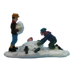 Kerstdorp kinderen in sneeuw
